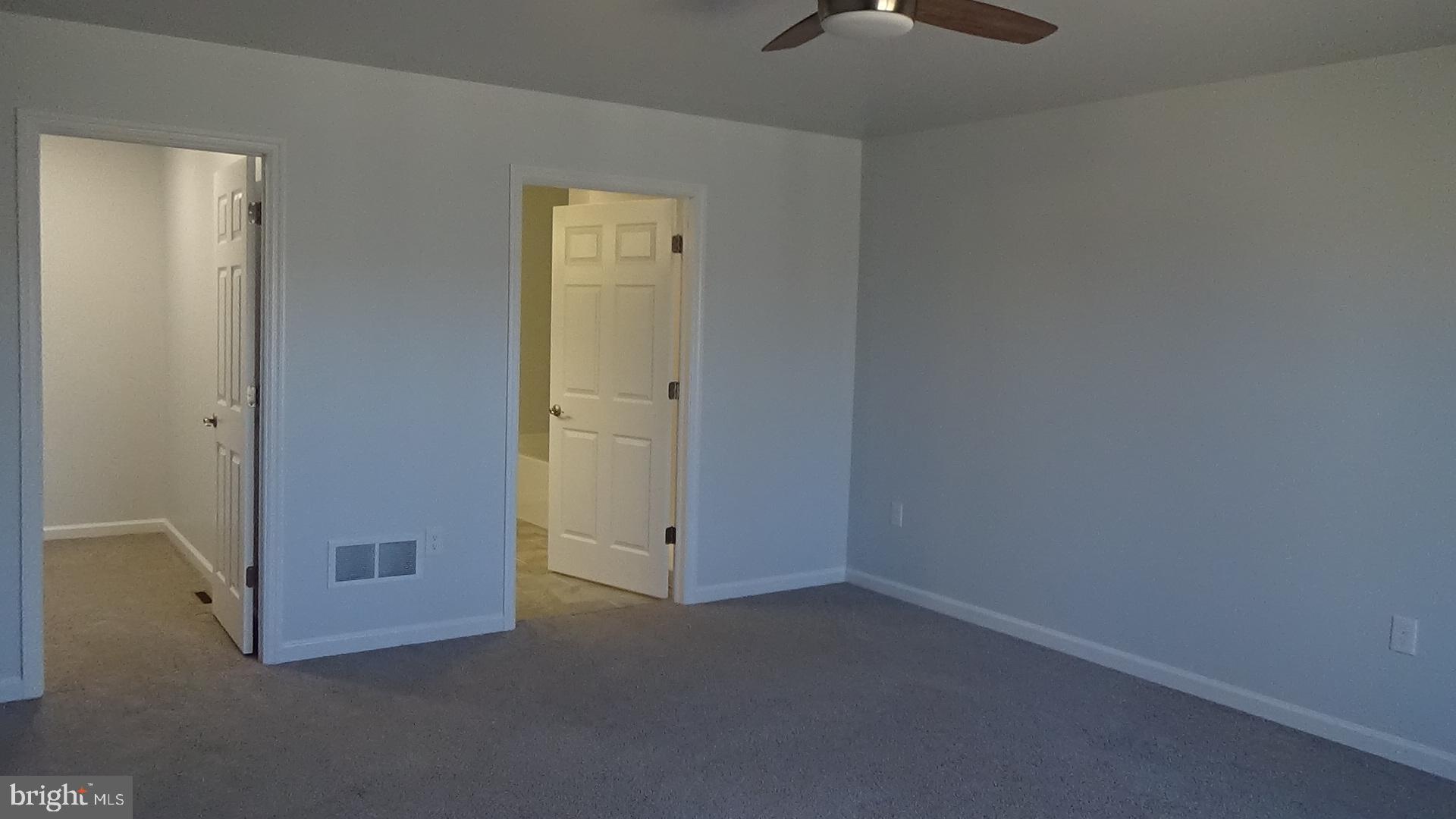 746 Hilltop Road Millerstown, PA 17062 - Photo 17 of 24 an empty room with a ceiling fan painted walls and window