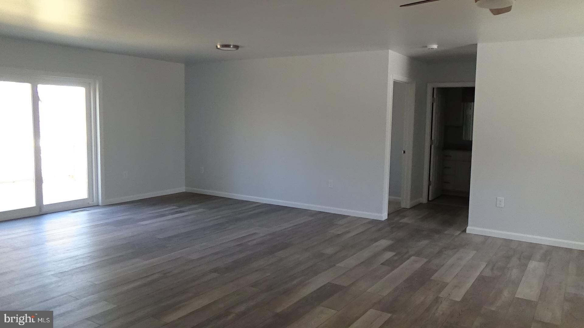 746 Hilltop Road Millerstown, PA 17062 - Photo 18 of 24 a view of an empty room with wooden floor and a window