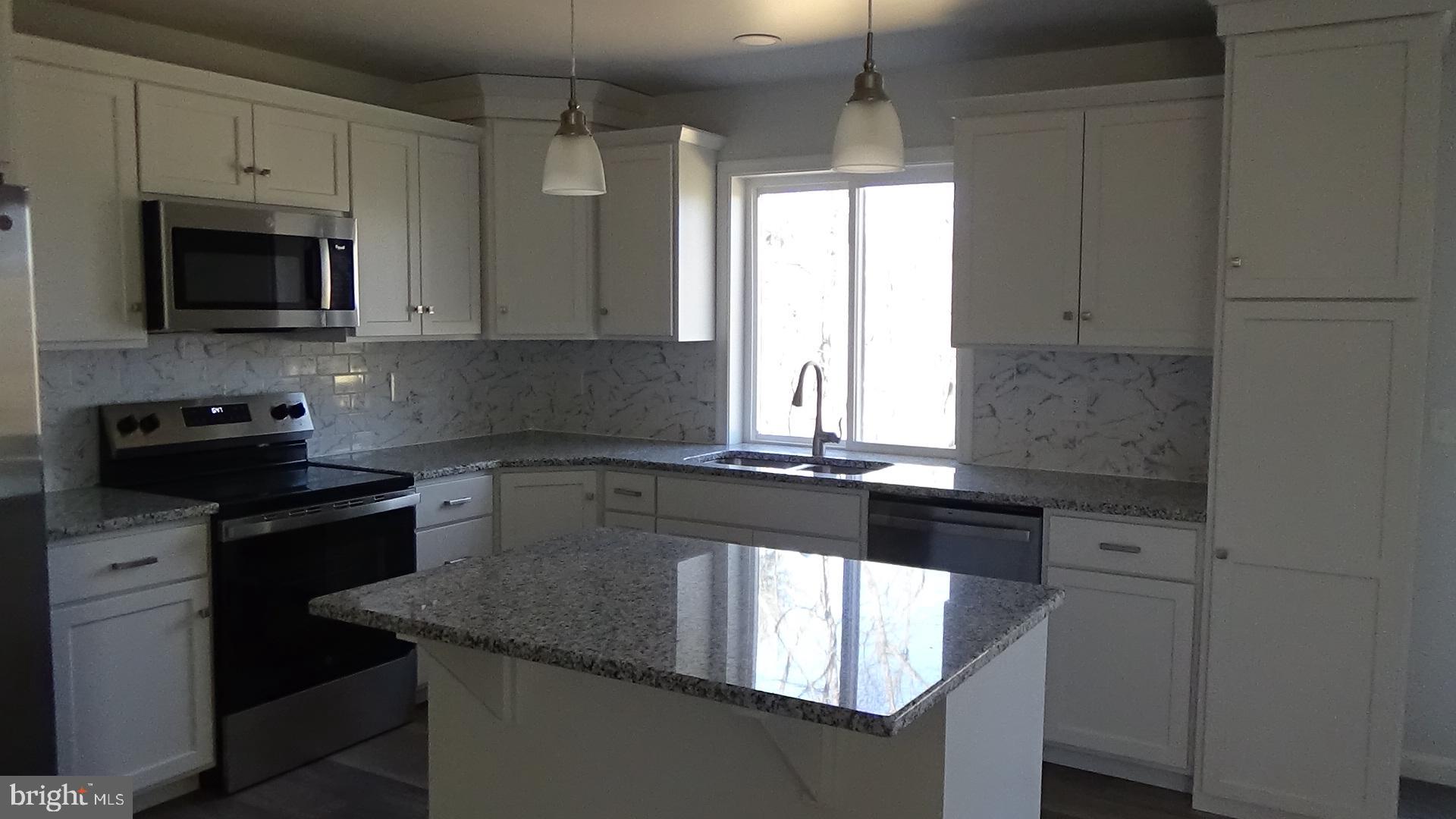 746 Hilltop Road Millerstown, PA 17062 - Photo 4 of 24 a kitchen with granite countertop white cabinets and black stainless steel appliances