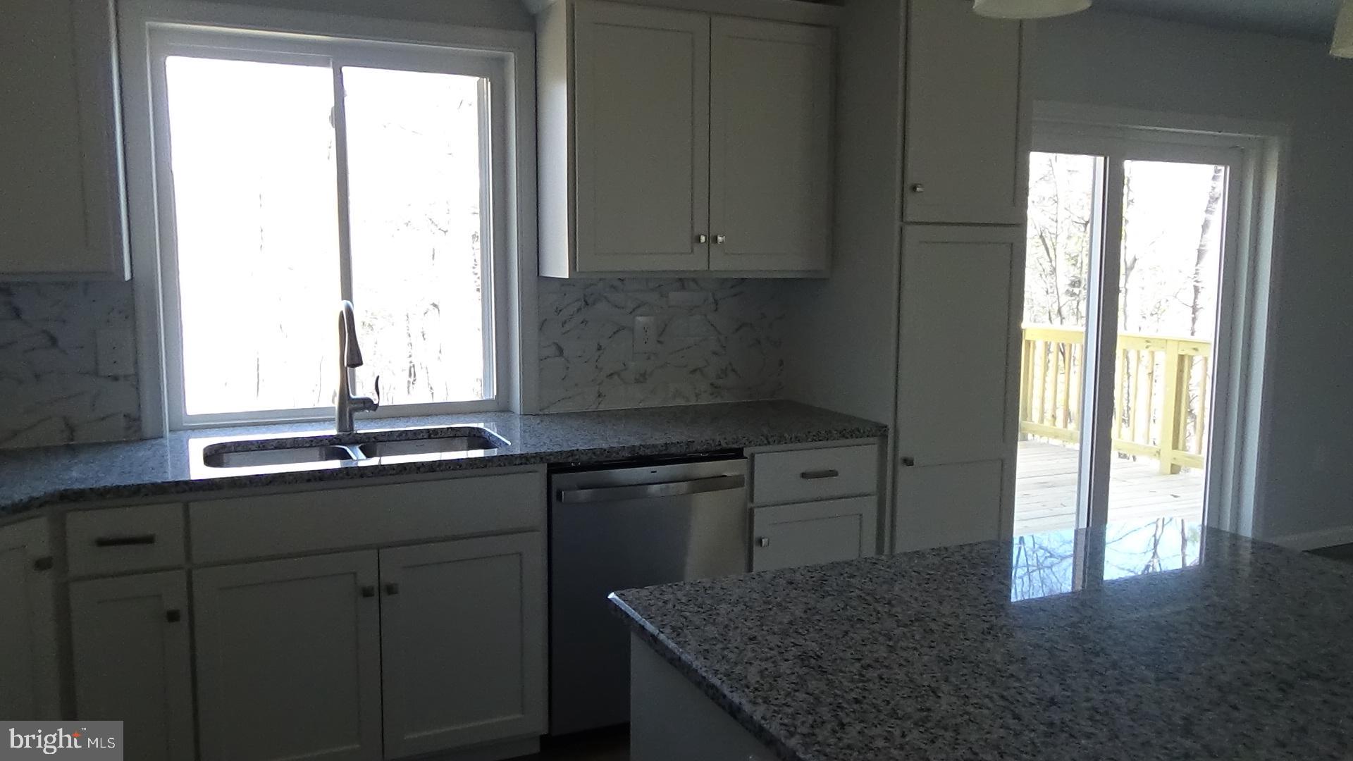 746 Hilltop Road Millerstown, PA 17062 - Photo 5 of 24 a kitchen with granite countertop a sink and a window