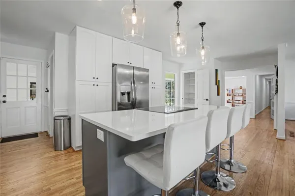a kitchen with kitchen island a sink stainless steel appliances and cabinets