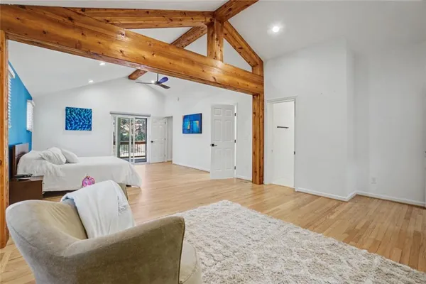 a view of a hallway with wooden floor and closet