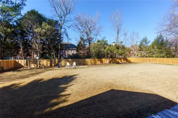 a view of a yard with plants and trees