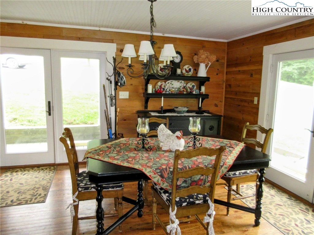 1294 Spencer Branch Road Lansing, NC 28643 - Photo 15 of 42 a view of a dining room with furniture window and wooden floor