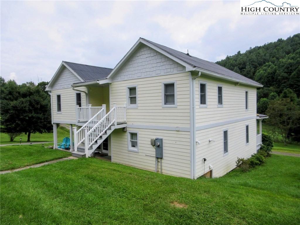 1294 Spencer Branch Road Lansing, NC 28643 - Photo 19 of 42 a view of a house with a yard and porch