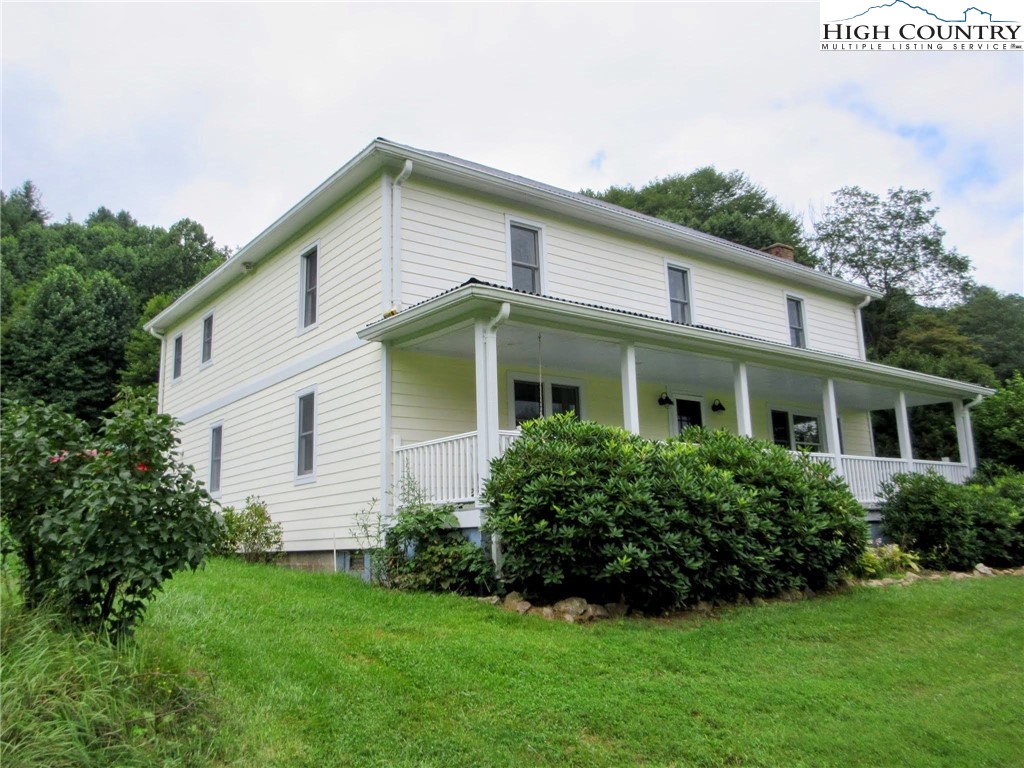 1294 Spencer Branch Road Lansing, NC 28643 - Photo 20 of 42 a front view of a house with a garden
