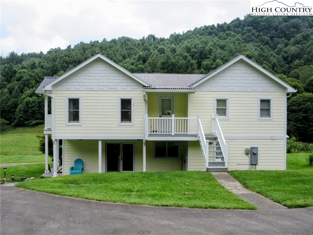 1294 Spencer Branch Road Lansing, NC 28643 - Photo 21 of 42 a front view of a house with a garden and yard