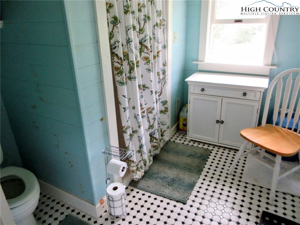 1294 Spencer Branch Road Lansing, NC 28643 - Photo 9 of 42 a bathroom with a sink toilet and shower