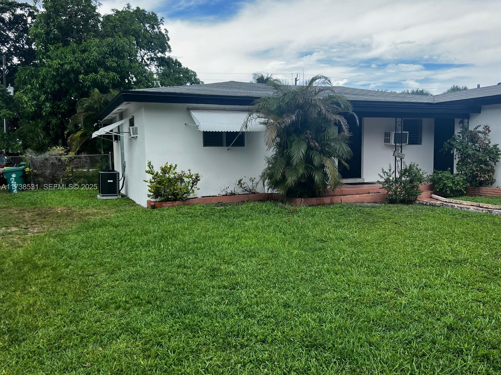 226 Southwest 6th Street, Unit A Dania Beach, FL 33004 - Photo 13 of 14 a front view of house with a garden