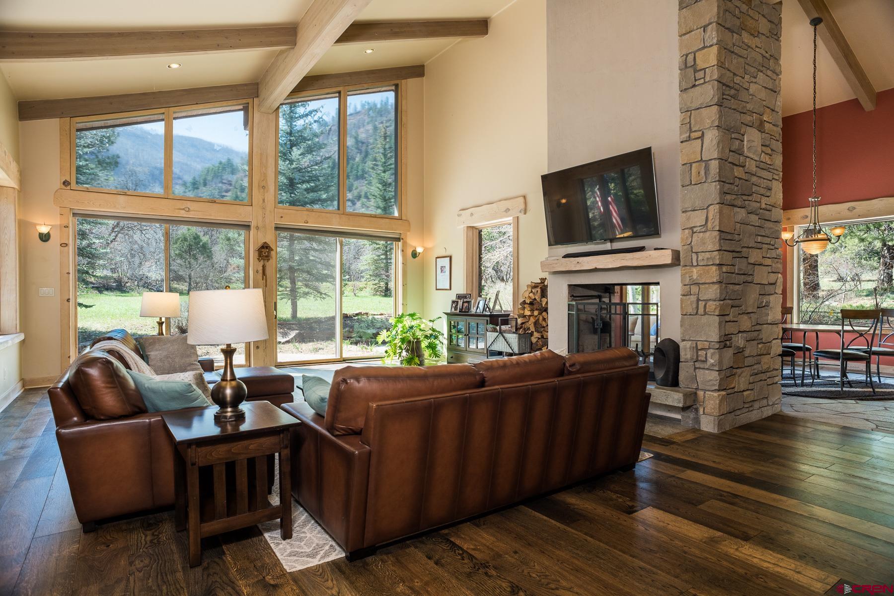 47 Mason Cabin Road Durango, CO 81301 - Photo 12 of 35 a living room with furniture a flat screen tv and a fireplace