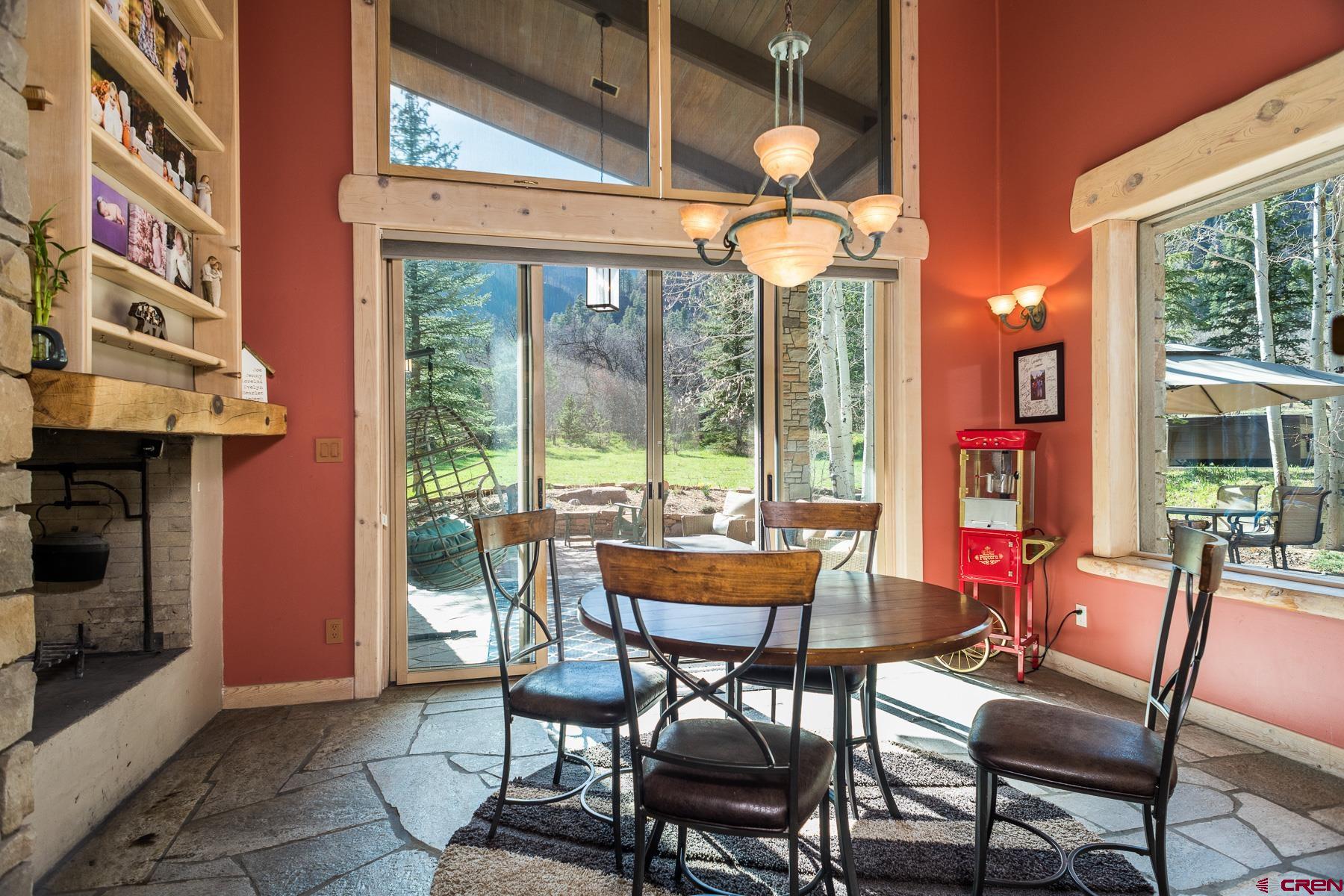 47 Mason Cabin Road Durango, CO 81301 - Photo 14 of 35 a dining room with furniture water view and a fireplace