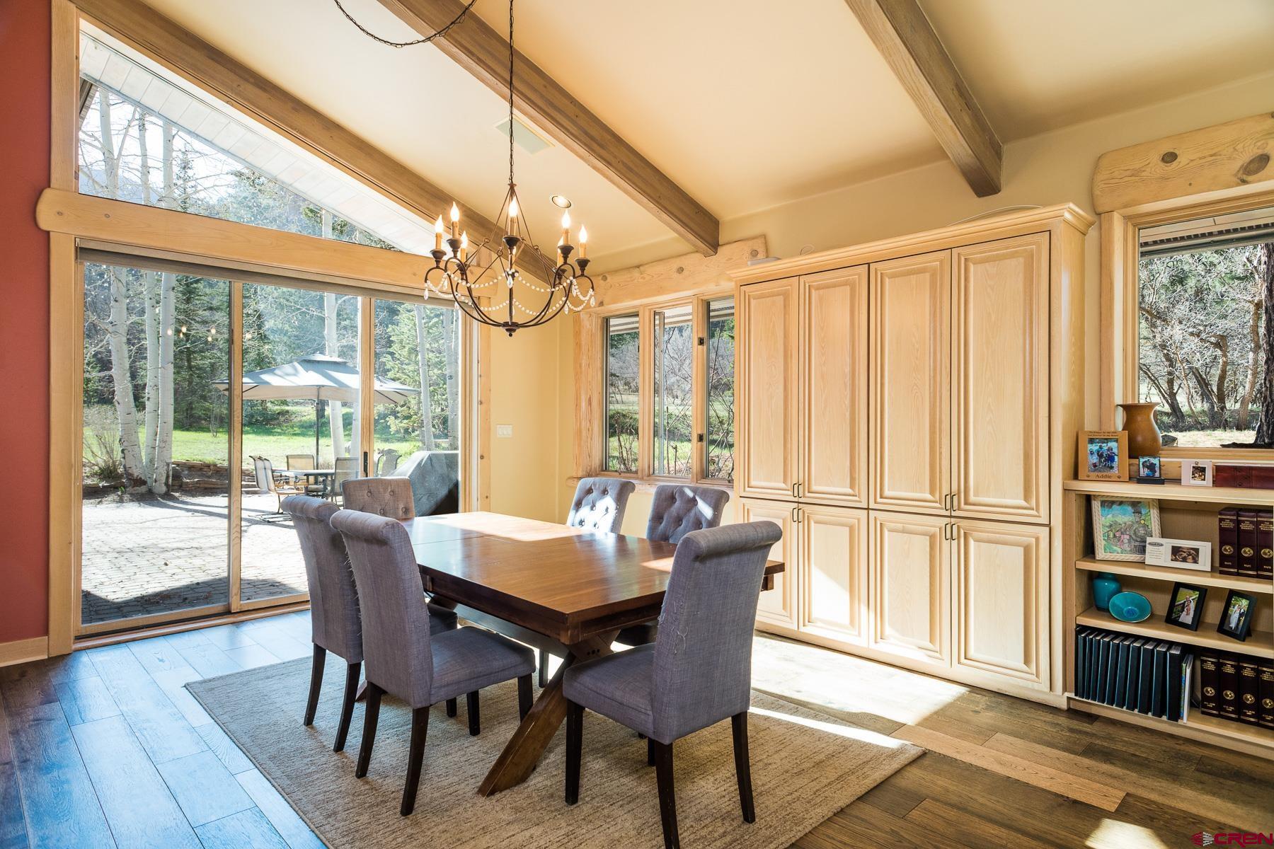 47 Mason Cabin Road Durango, CO 81301 - Photo 17 of 35 a dining room with furniture large window and wooden floor