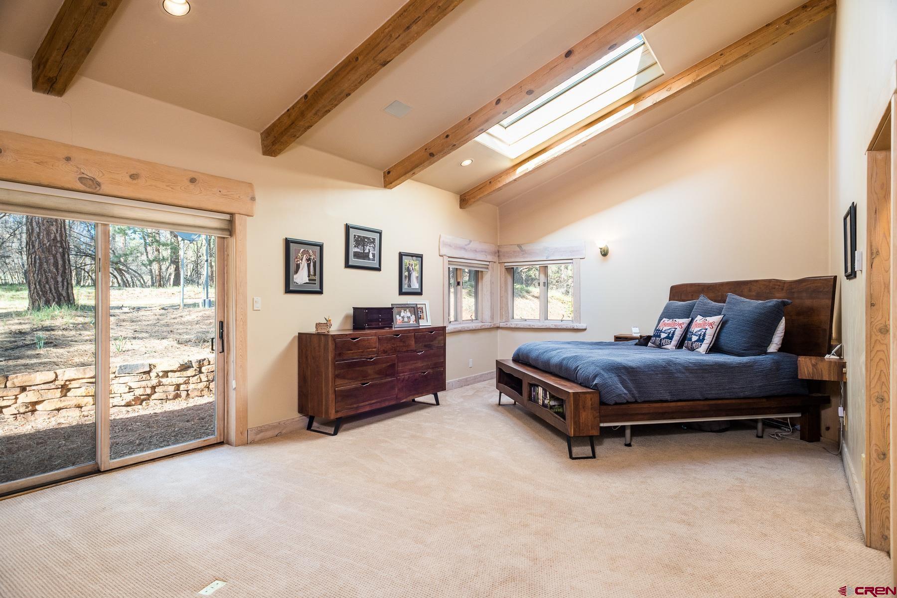 47 Mason Cabin Road Durango, CO 81301 - Photo 18 of 35 a bedroom with a bed and wooden floor