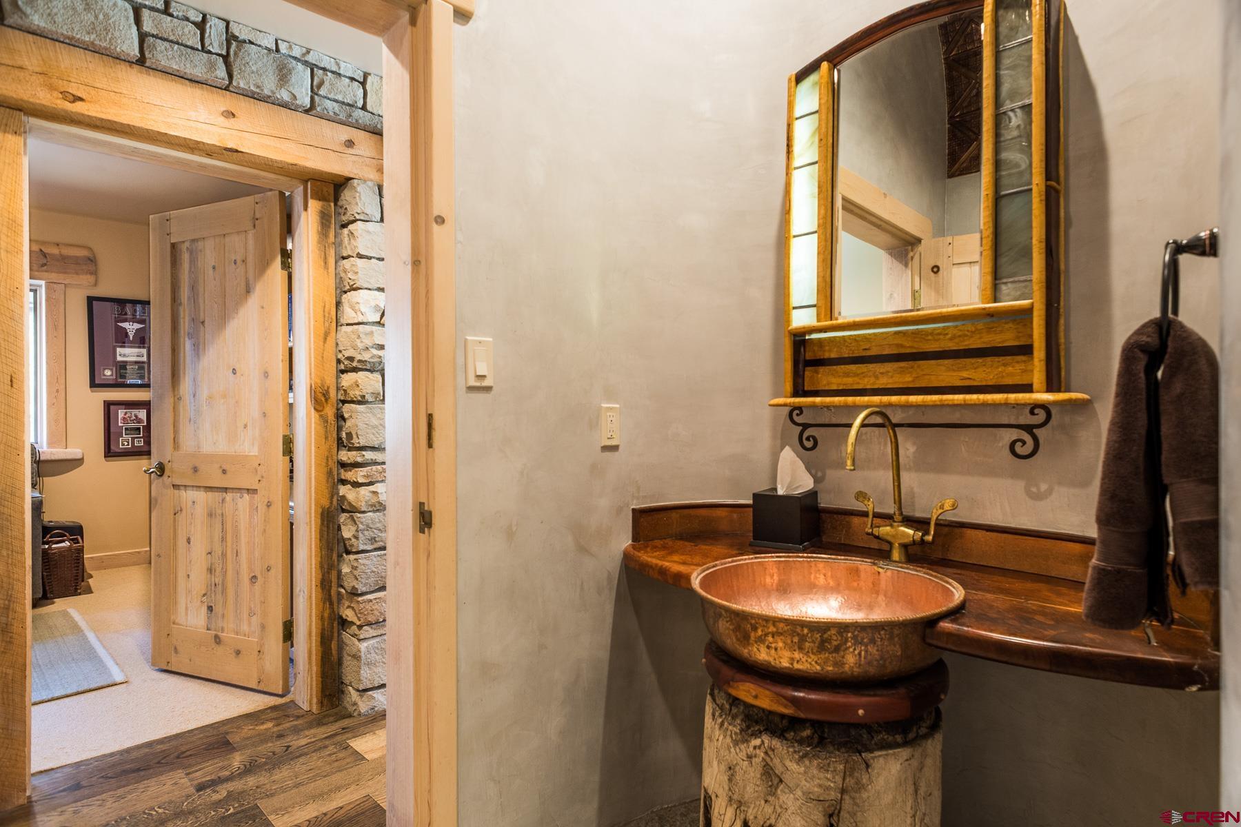 47 Mason Cabin Road Durango, CO 81301 - Photo 23 of 35 a bathroom with a sink a mirror and a shower