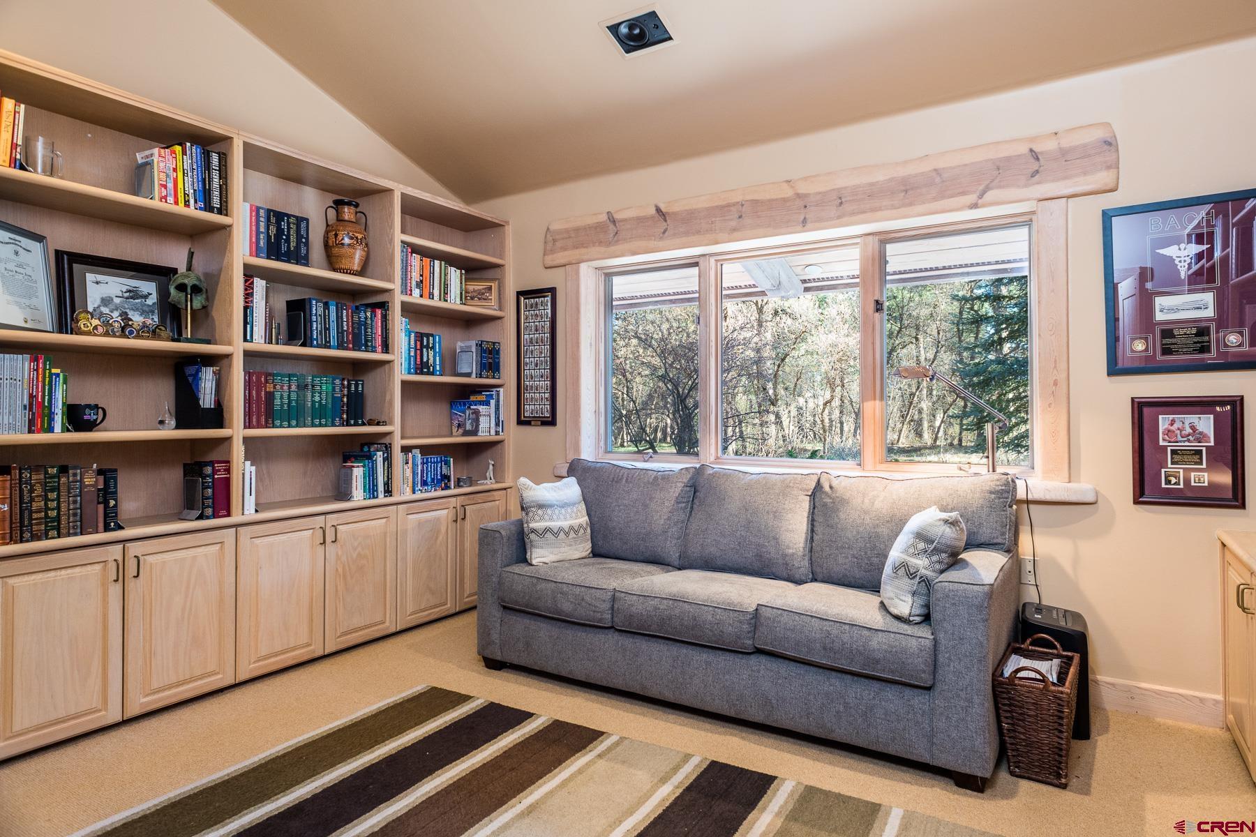 47 Mason Cabin Road Durango, CO 81301 - Photo 25 of 35 a living room with furniture and a book shelf