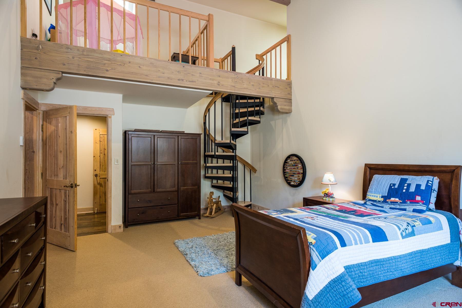 47 Mason Cabin Road Durango, CO 81301 - Photo 29 of 35 a bedroom with a bed and a closet