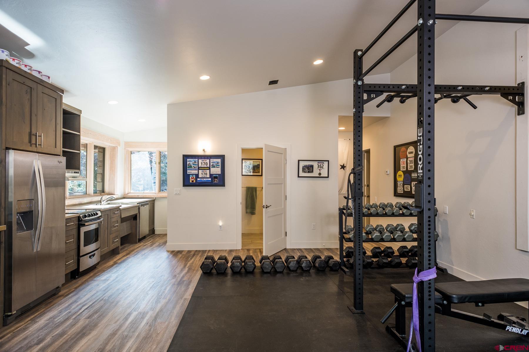 47 Mason Cabin Road Durango, CO 81301 - Photo 32 of 35 a kitchen with refrigerator a stove and wooden floor