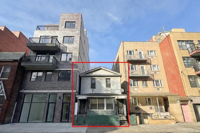 a front view of a residential apartment building with a yard