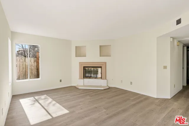 a kitchen with a refrigerator a stove top oven and white cabinets