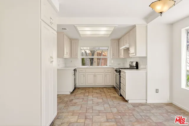 a bedroom with a large bed and a large window