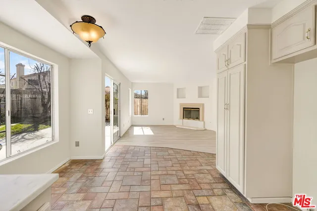 an empty room with wooden floor and a window
