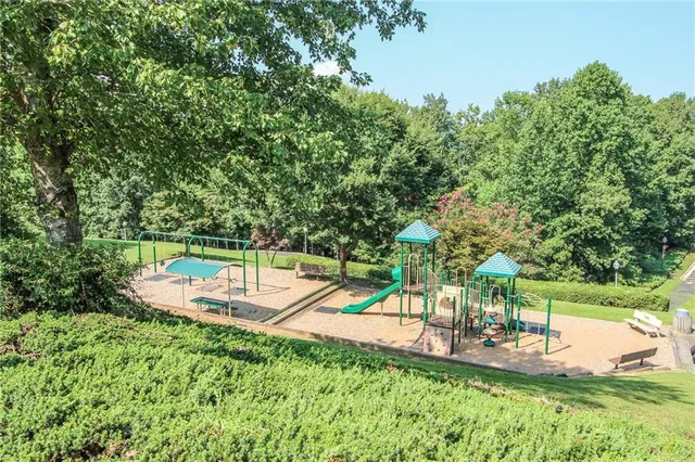 a view of a park with bench on the road