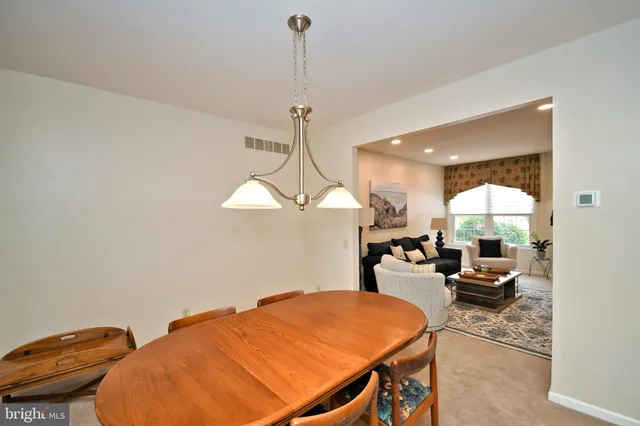 a view of a livingroom and a kitchen with a table chairs