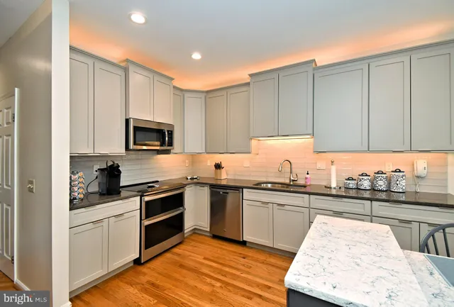 a kitchen with a sink stove and cabinets