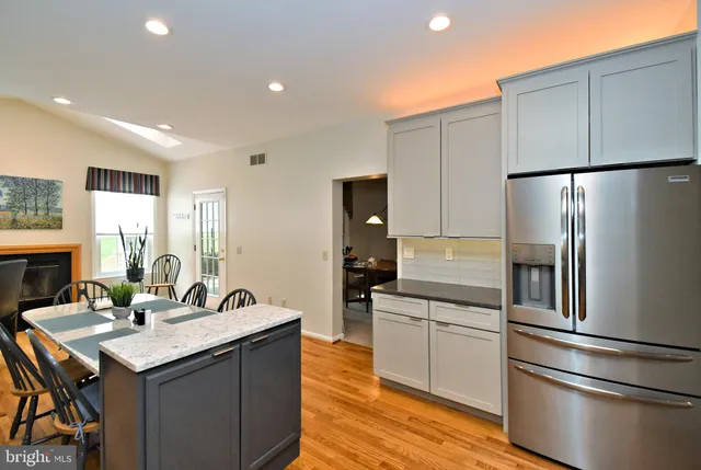 a kitchen with refrigerator cabinets and wooden floor