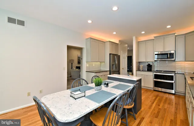 a living room with furniture a potted plant and a fireplace