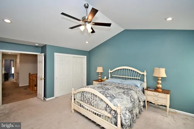 a bedroom with a bed chandelier and a window