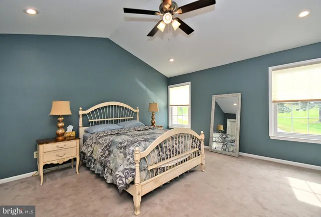 a bathroom with a bathtub a sink a toilet and a window