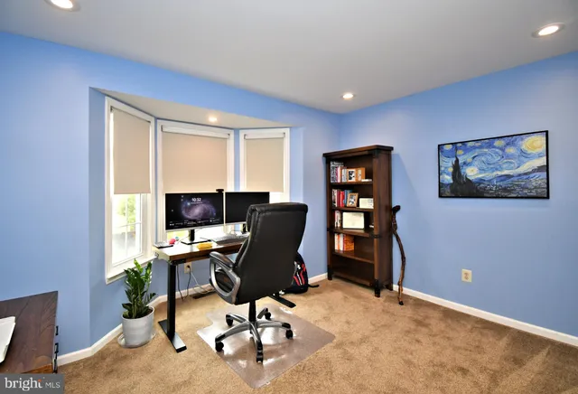a bathroom with a granite countertop toilet and a sink