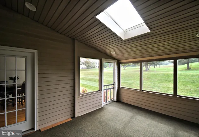 a view of a green field with trees