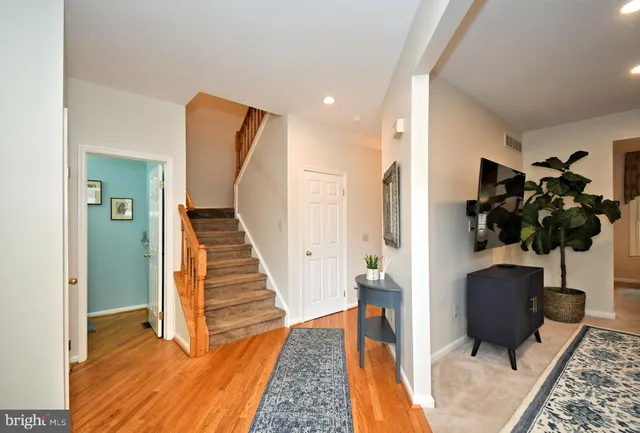 a view of entryway and hall with wooden floor