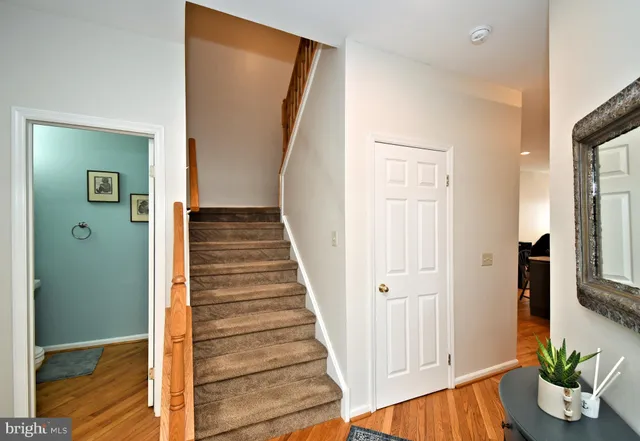 a view of a hallway with wooden floor and entryway