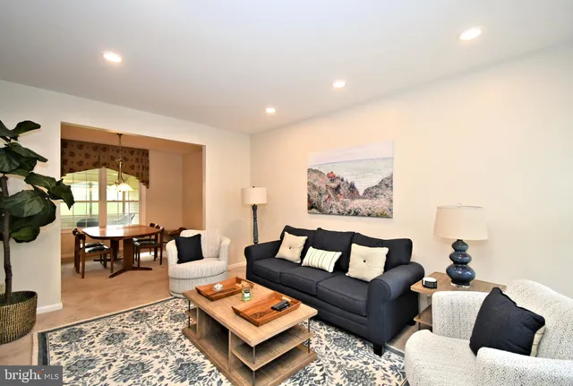 a living room with furniture a rug and a window