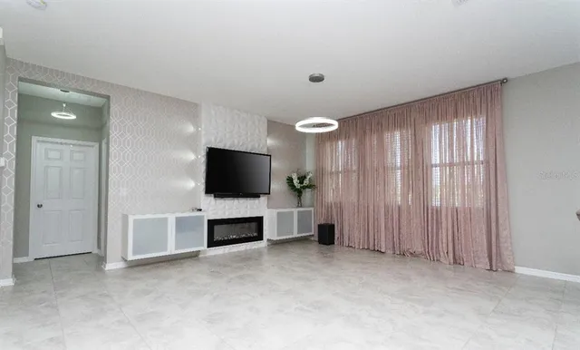 an empty room with furniture and window