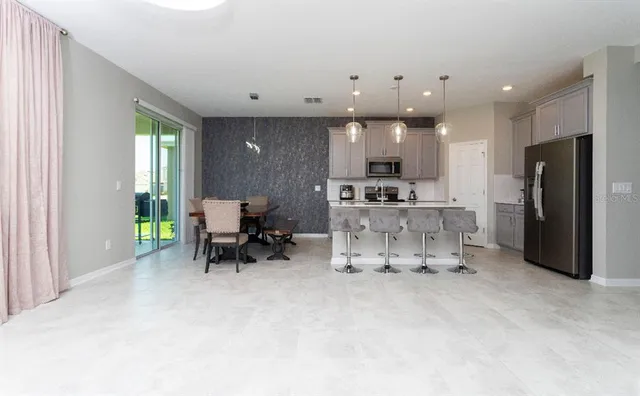 a living room with furniture and a open kitchen