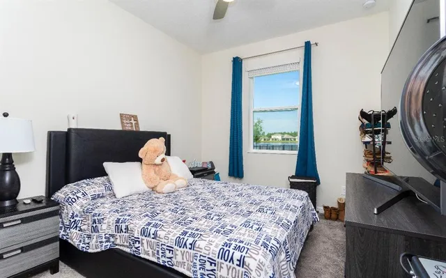 a bedroom with a bed and dresser with mirror