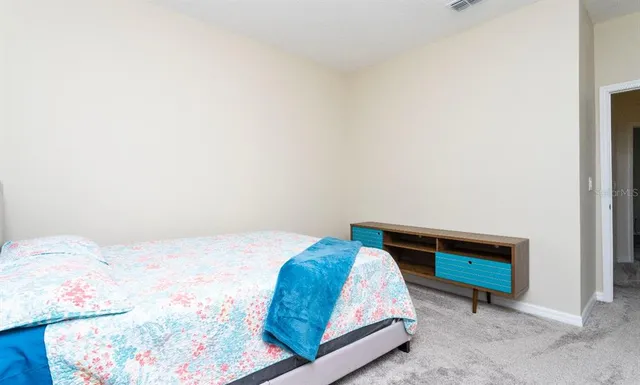 a bedroom with a bed and chair