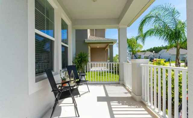 a view of a house with a wooden bench in a porch
