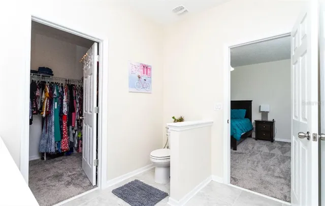 a living room with furniture and a toilet