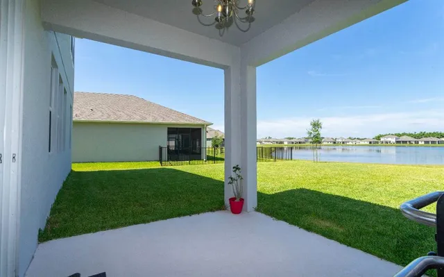 a view of a house with a yard and a patio
