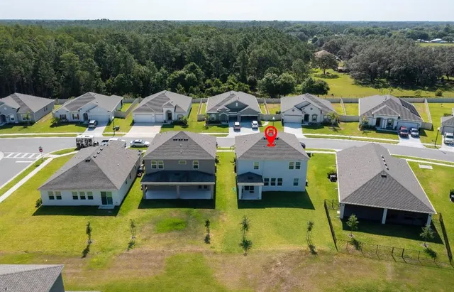 a aerial view of a house with swimming pool