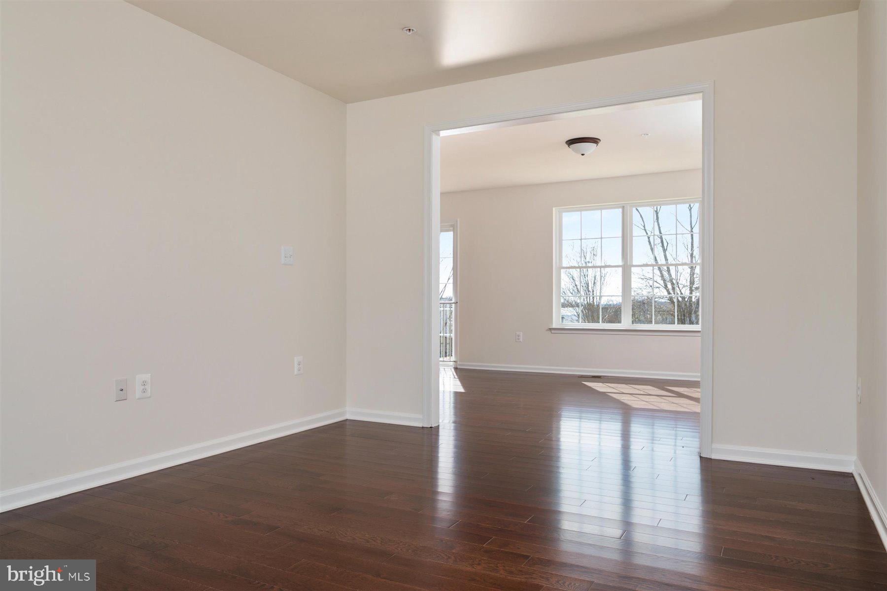 7412 Rossville Boulevard Rosedale, MD 21237 - Photo 11 of 37 an empty room with wooden floor and windows