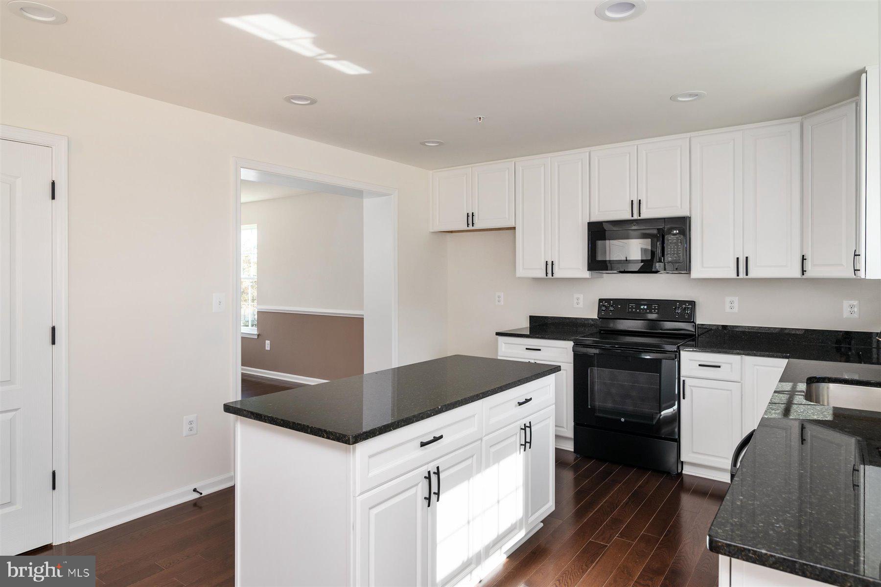 7412 Rossville Boulevard Rosedale, MD 21237 - Photo 15 of 37 a kitchen with granite countertop a stove and a sink