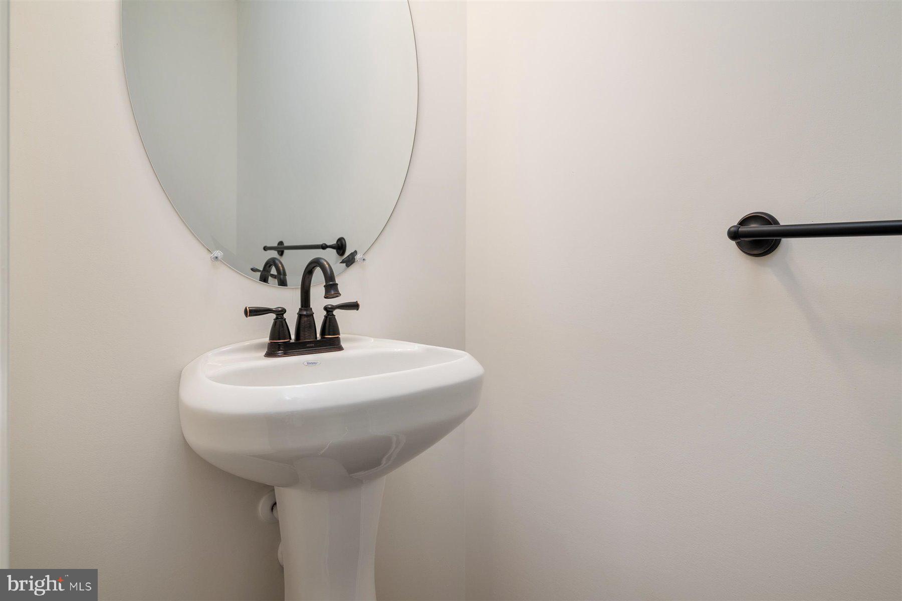 7412 Rossville Boulevard Rosedale, MD 21237 - Photo 17 of 37 a bathroom with a sink and mirror