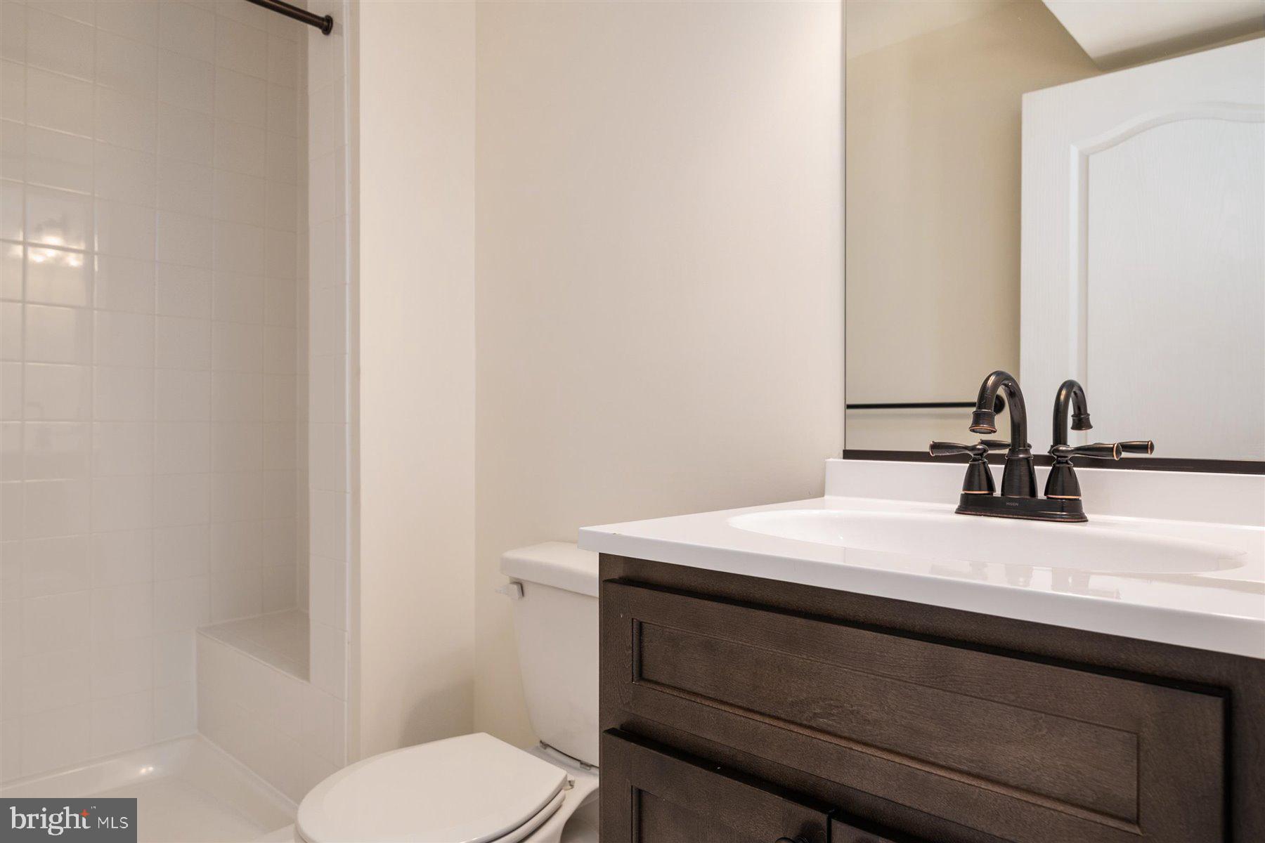 7412 Rossville Boulevard Rosedale, MD 21237 - Photo 34 of 37 a bathroom with a sink a toilet and mirror