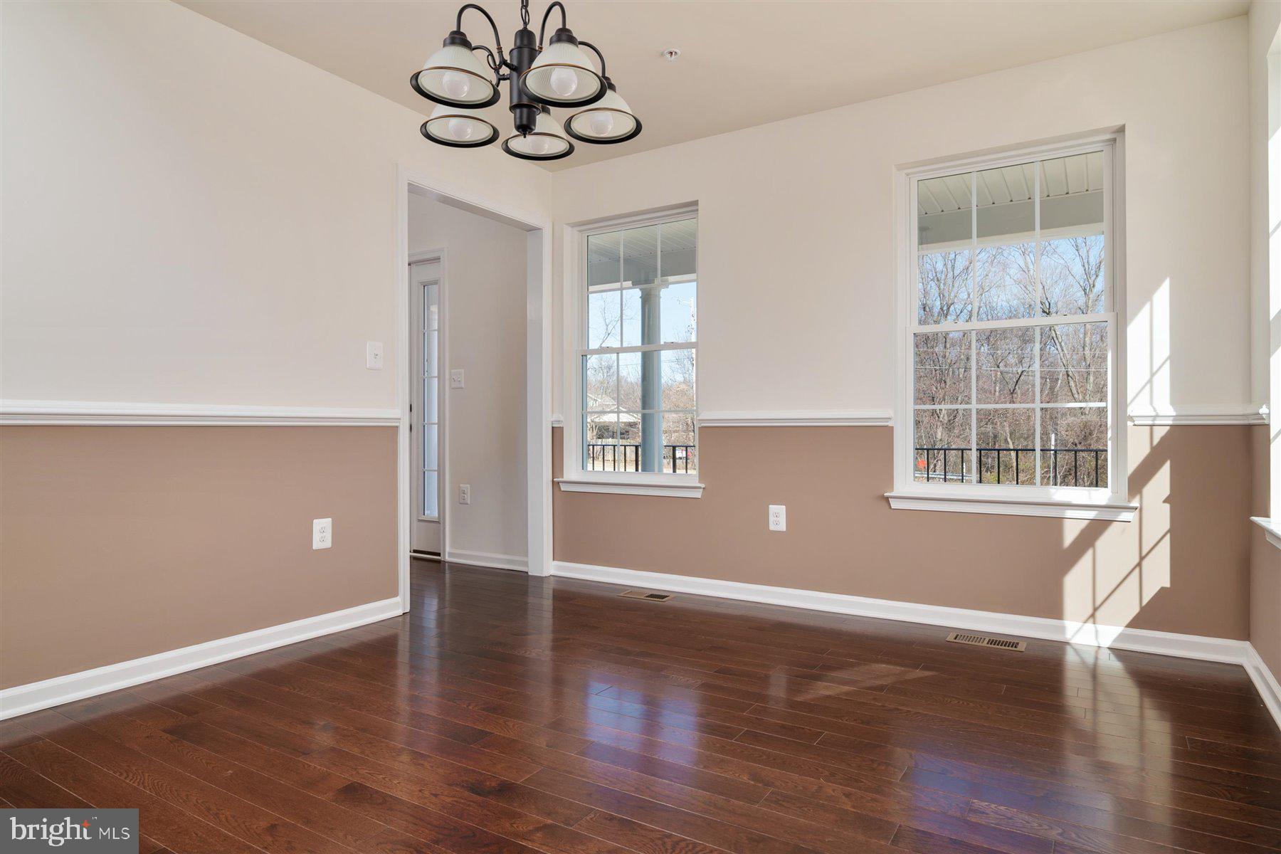 7412 Rossville Boulevard Rosedale, MD 21237 - Photo 9 of 37 a view of wooden floor and windows in a room